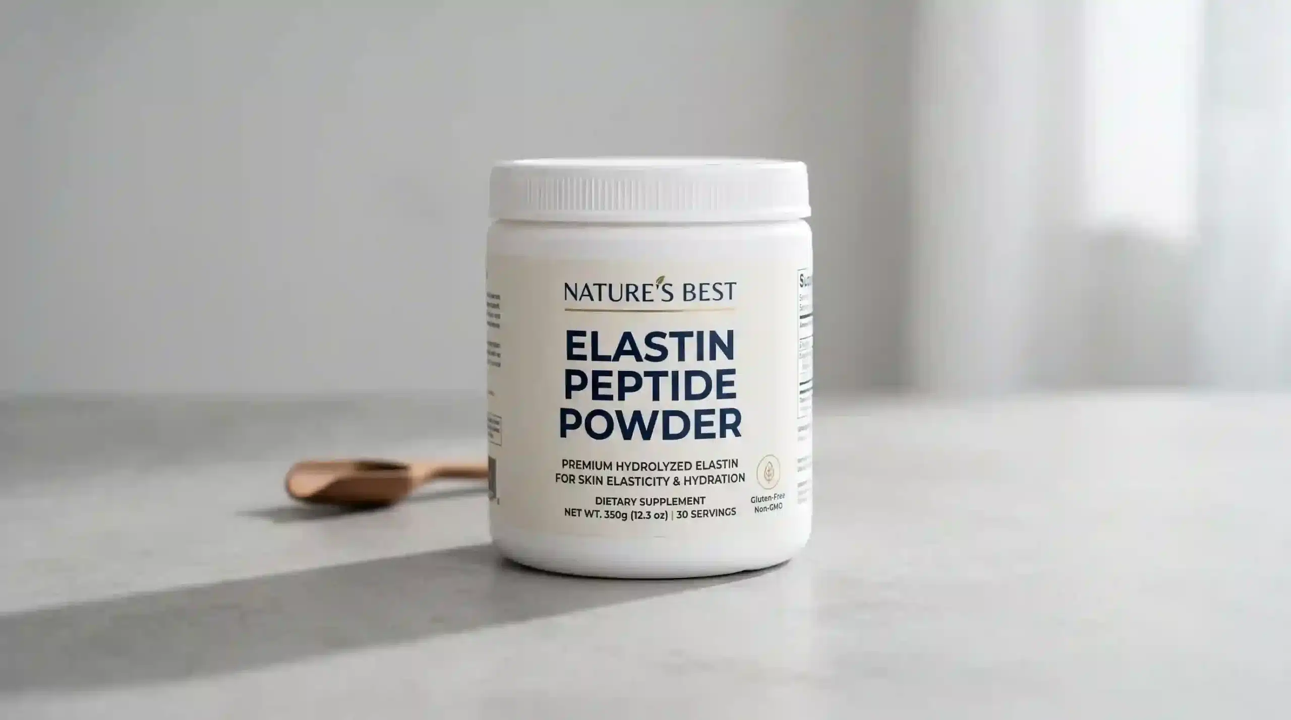 Atnutra elastin peptide powder product shot in a white plastic jar with simple label, placed on a light gray surface with soft studio lighting and subtle shadow.