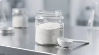 Elastin peptide powder in glass jar with scoop on laboratory table