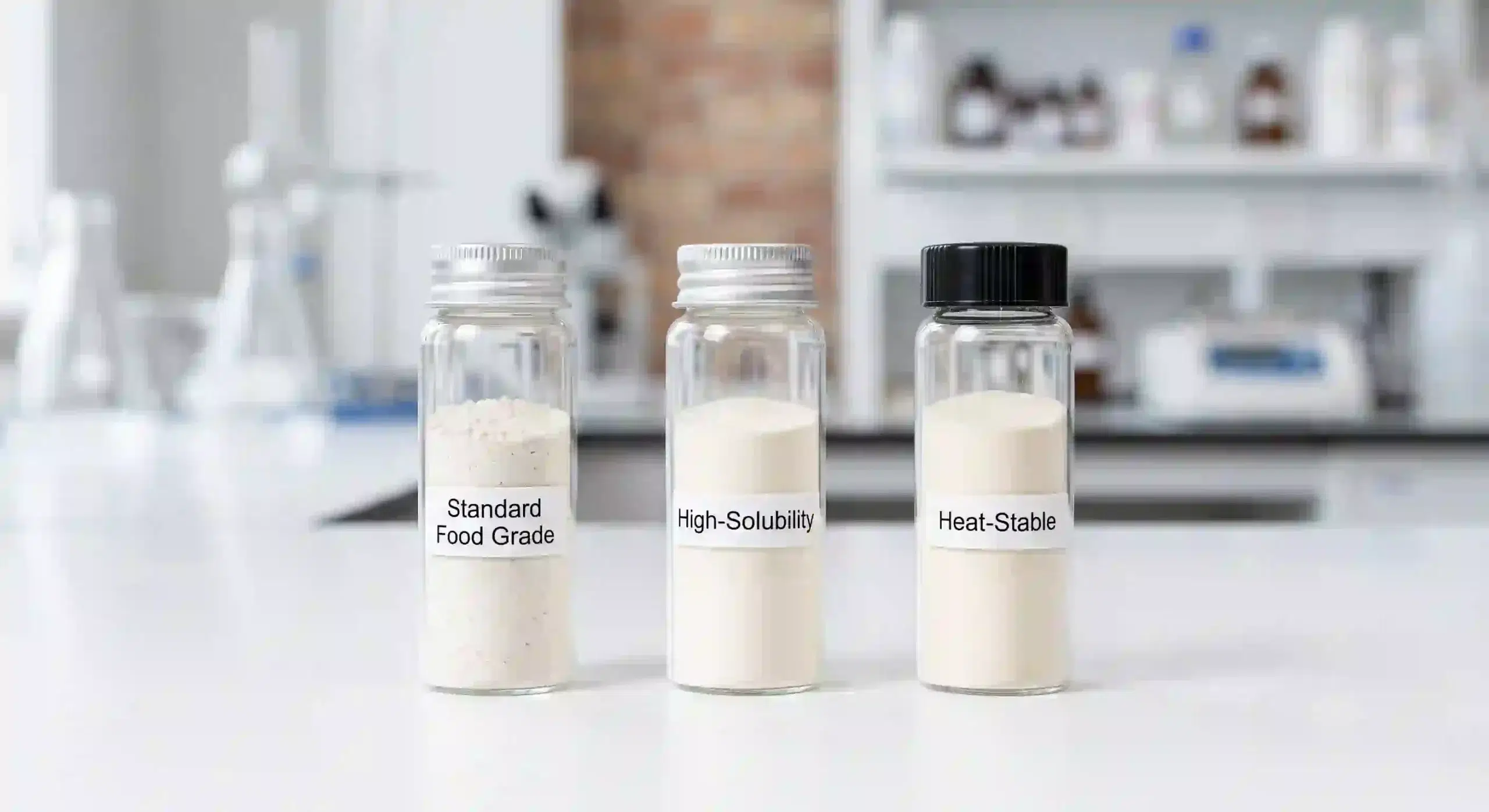 Three labeled glass vials containing different food‑grade keratin powder grades: standard, high‑solubility, and heat‑stable.